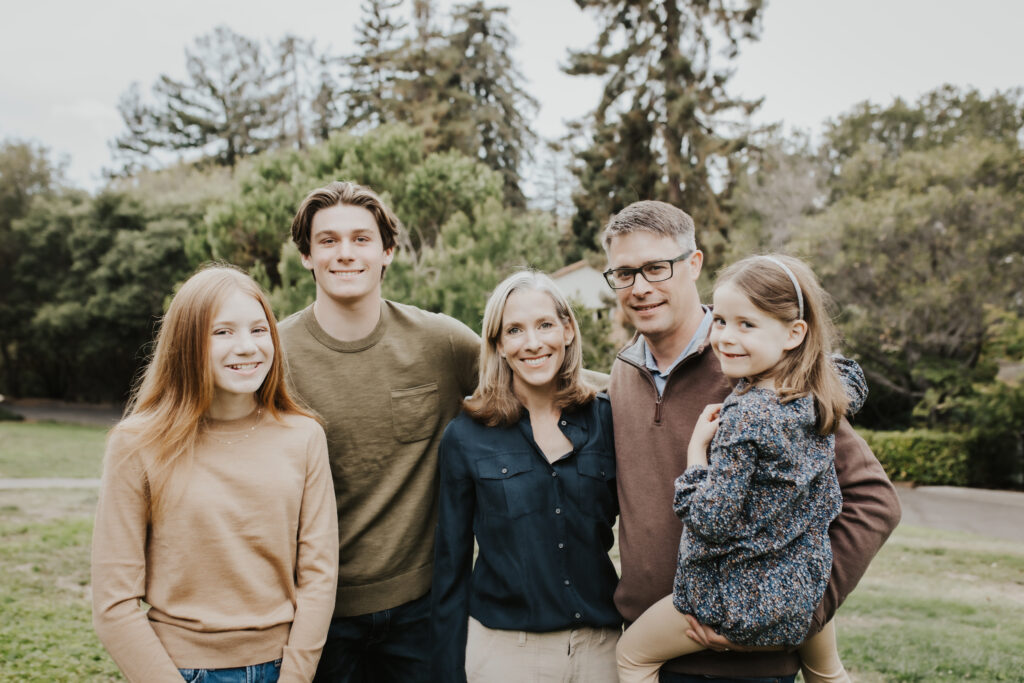 Leslie Olsen outdoors with her husband and three children