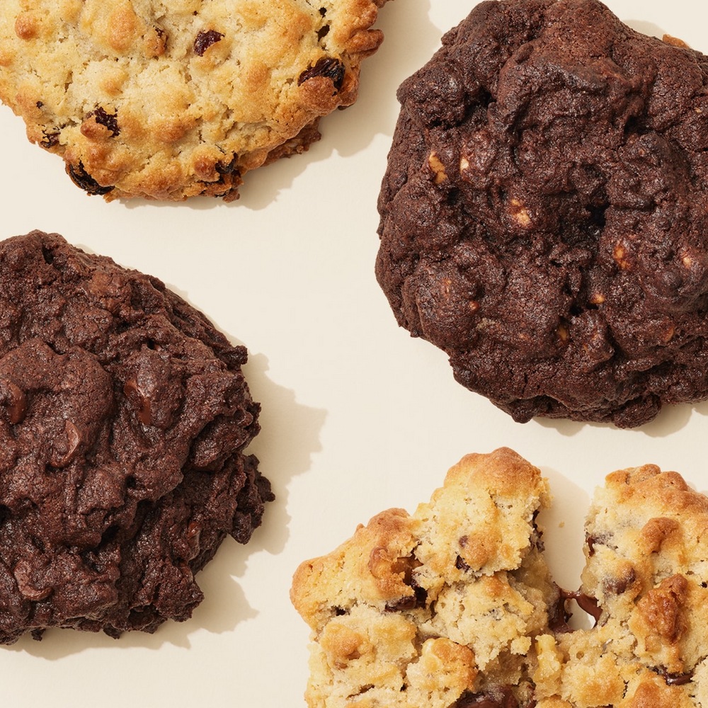Levain’s four original cookie flavors, including a broken chocolate chip walnut cookie