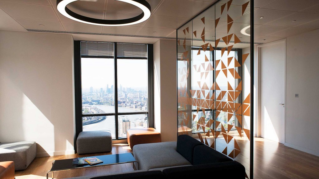 Archival Level39 lounge with patterned glass, sofas and a view over London