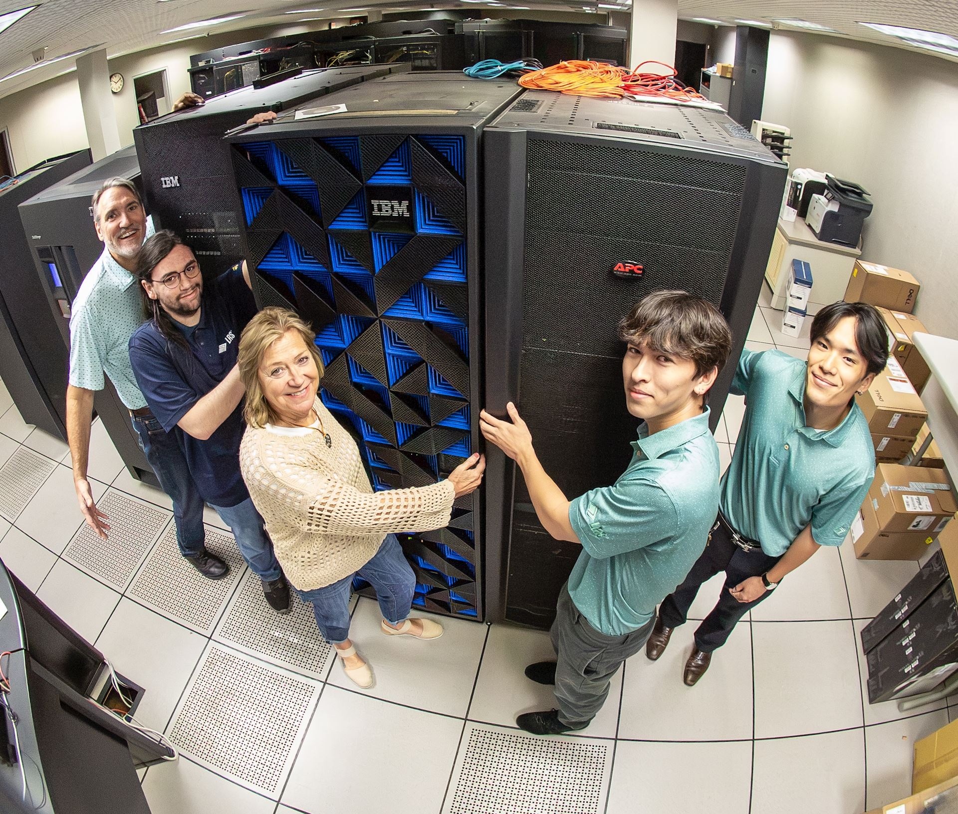 Five LRS staff members gathered around an IBM mainframe