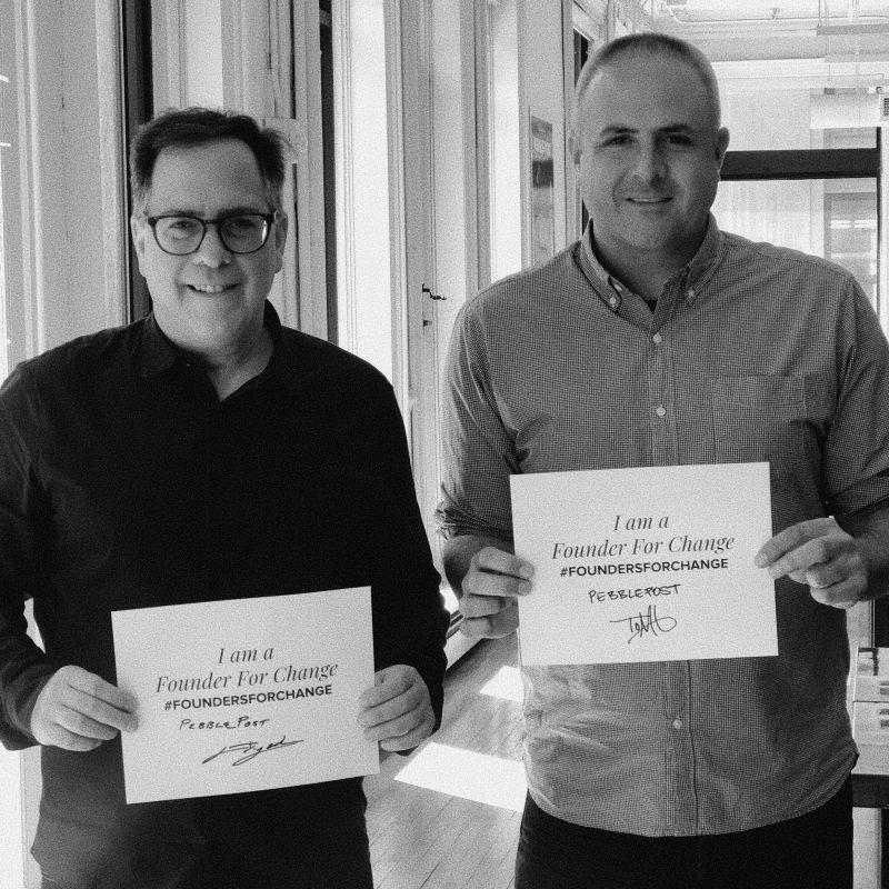 Lewis Gersh, left, and Tom Gibbons holding Founders for Change signs