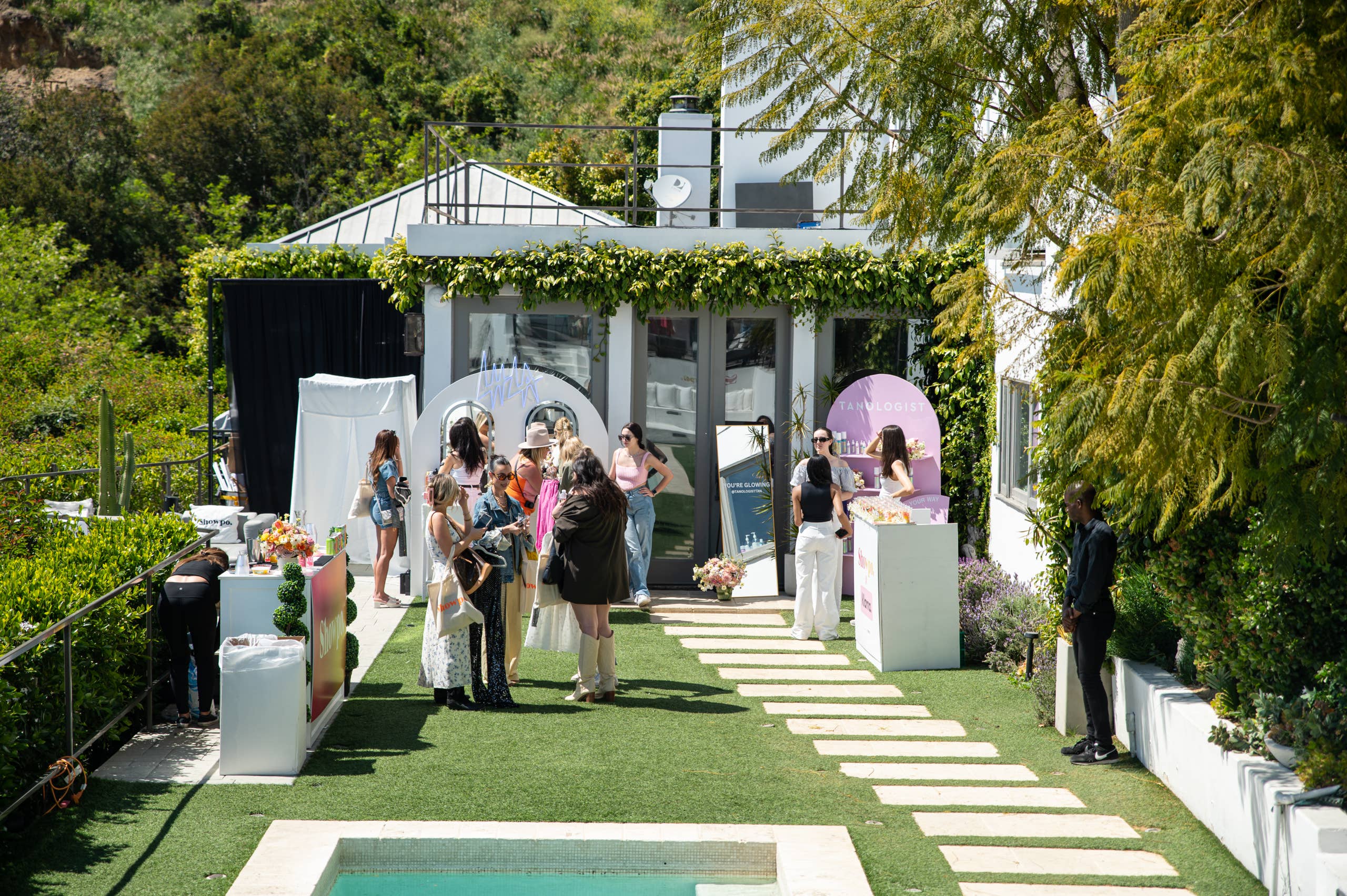 Guests at Showpo’s 2023 Coachella collection preview in a garden outside a Hollywood Hills house