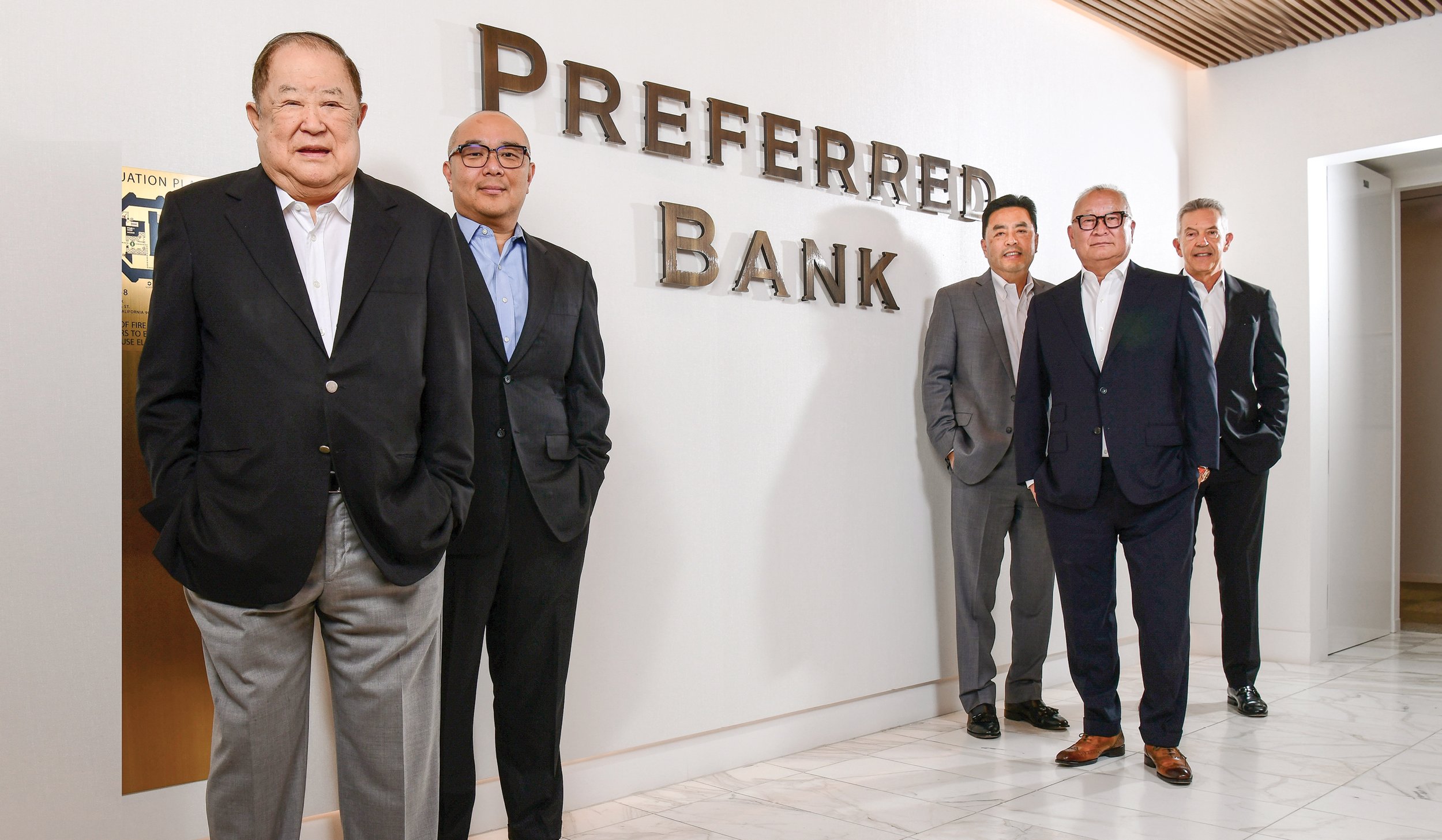 Li Yu, at left, with four fellow Preferred Bank executives in the bank’s offices