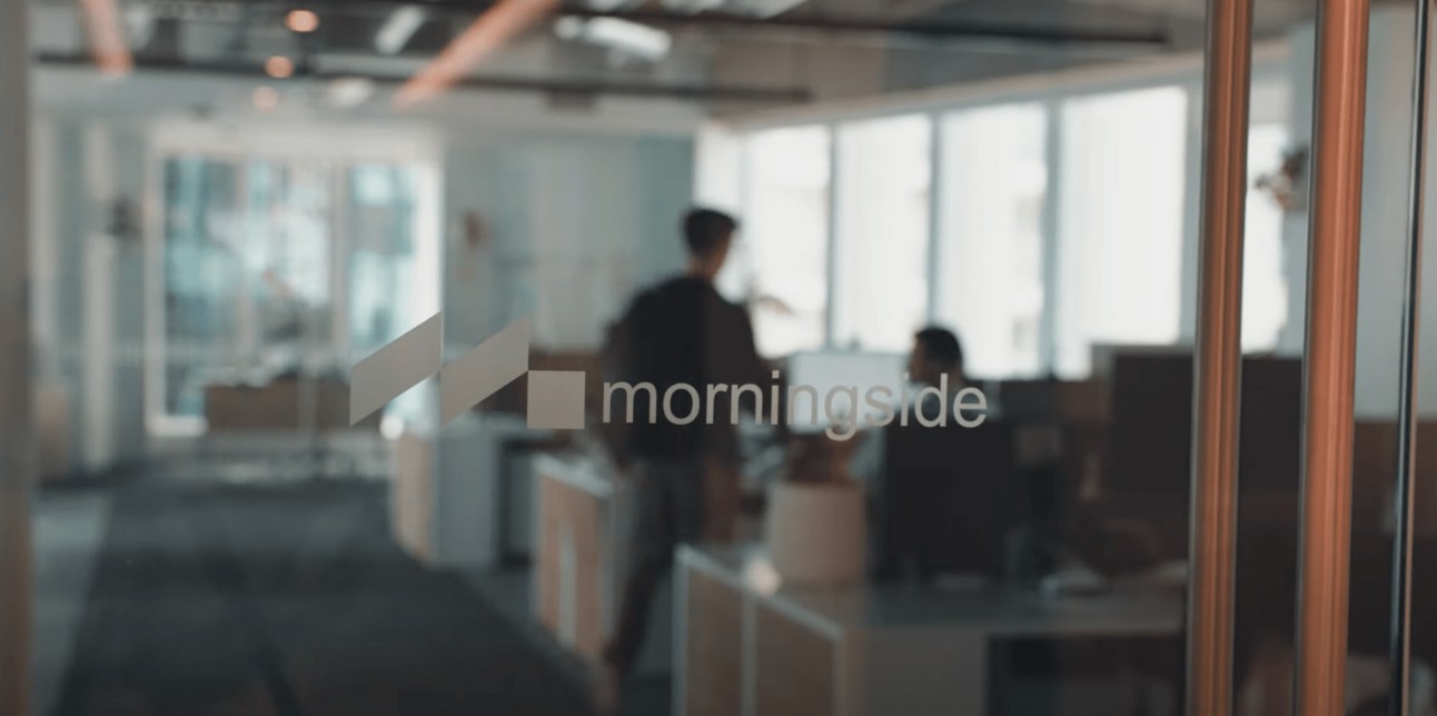 View through the glass entrance of the Morningside AI office in Auckland
