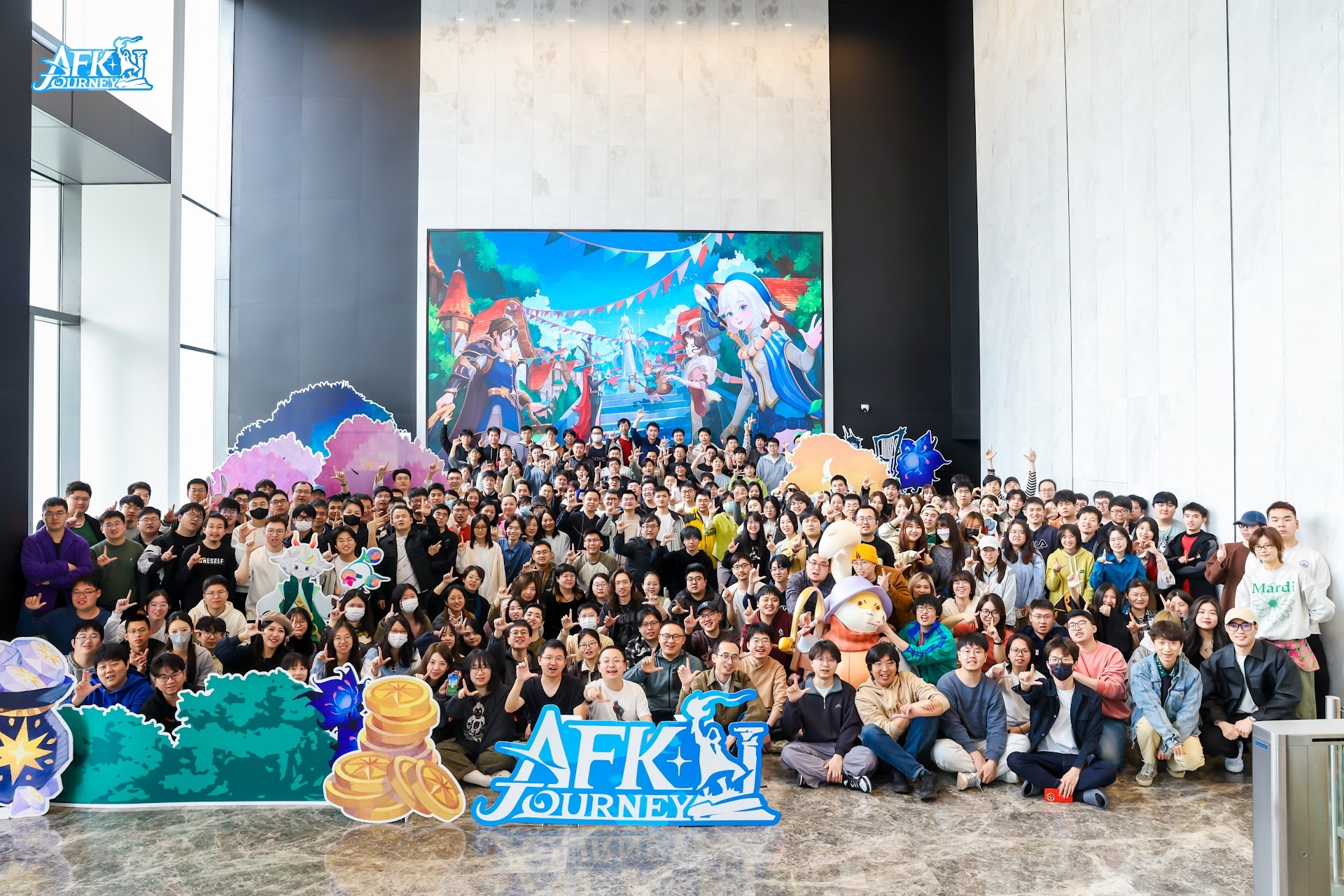 AFK Journey’s development team gathered around character displays