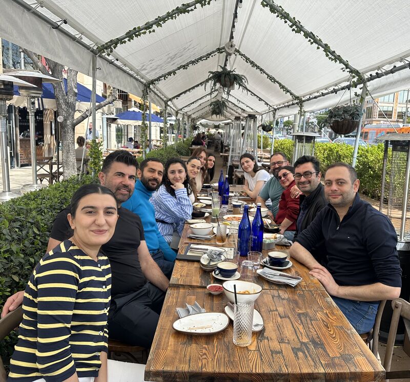 A group gathered around an outdoor breakfast table in a photograph shared by Lilya Avagyan.