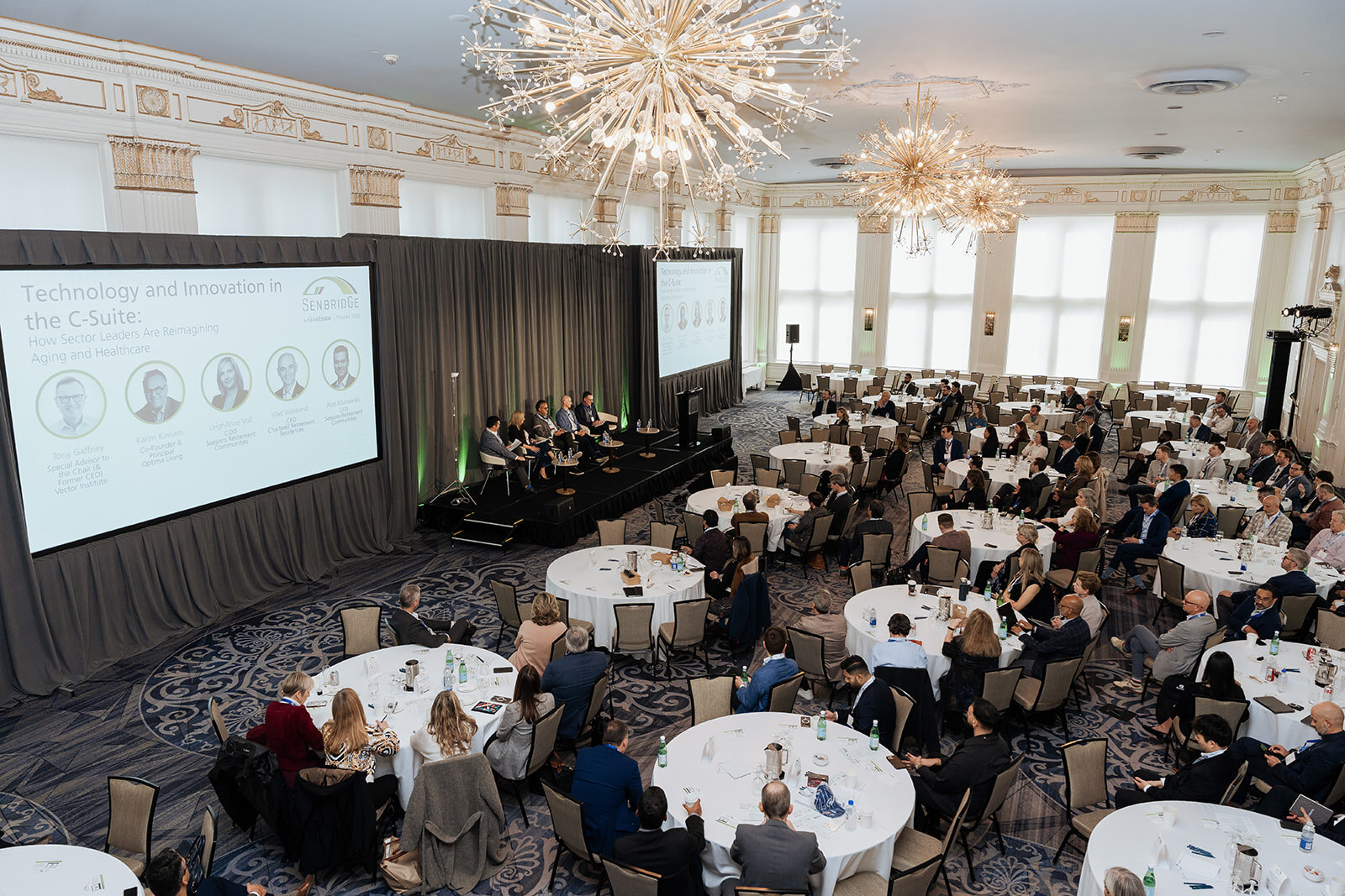 A wide view of attendees seated at round tables during the SenbridGe Toronto 2025 conference