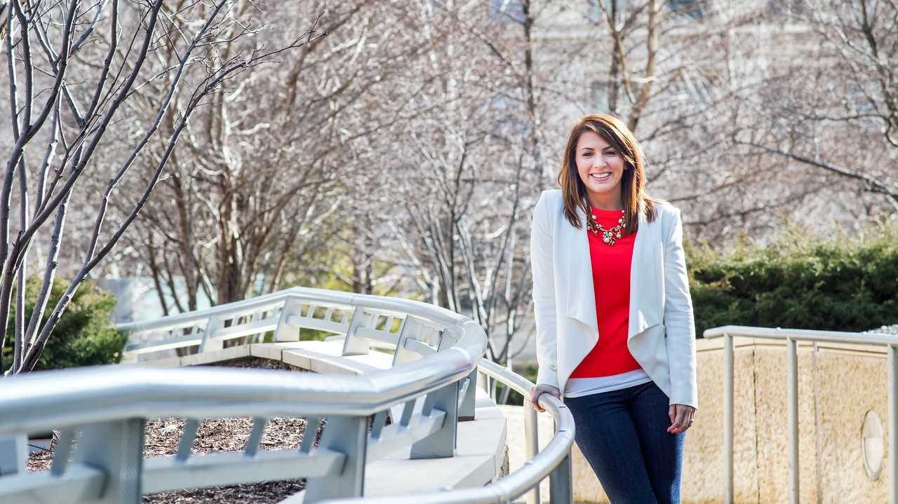 Lindsay Wasson Lingle standing outdoors beside a curved metal railing