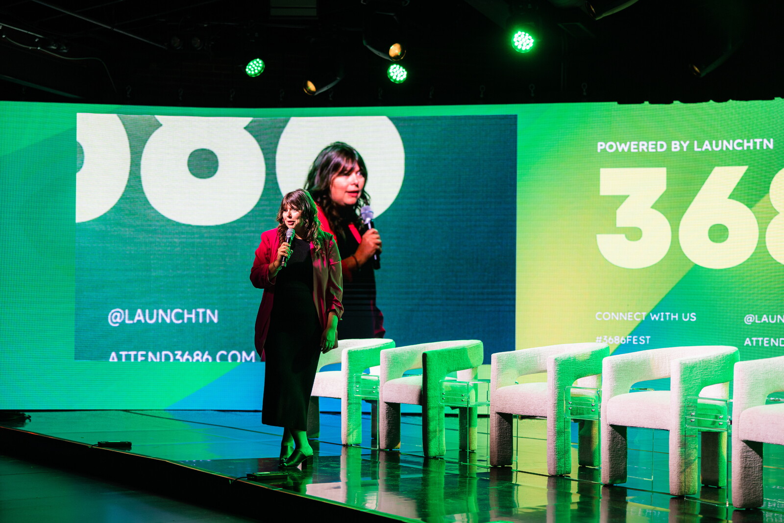 Lindsey Cox holding a microphone onstage at the 2024 3686 conference