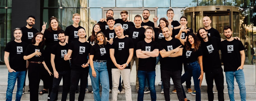 The Linx team standing outside a building in matching black Linx shirts