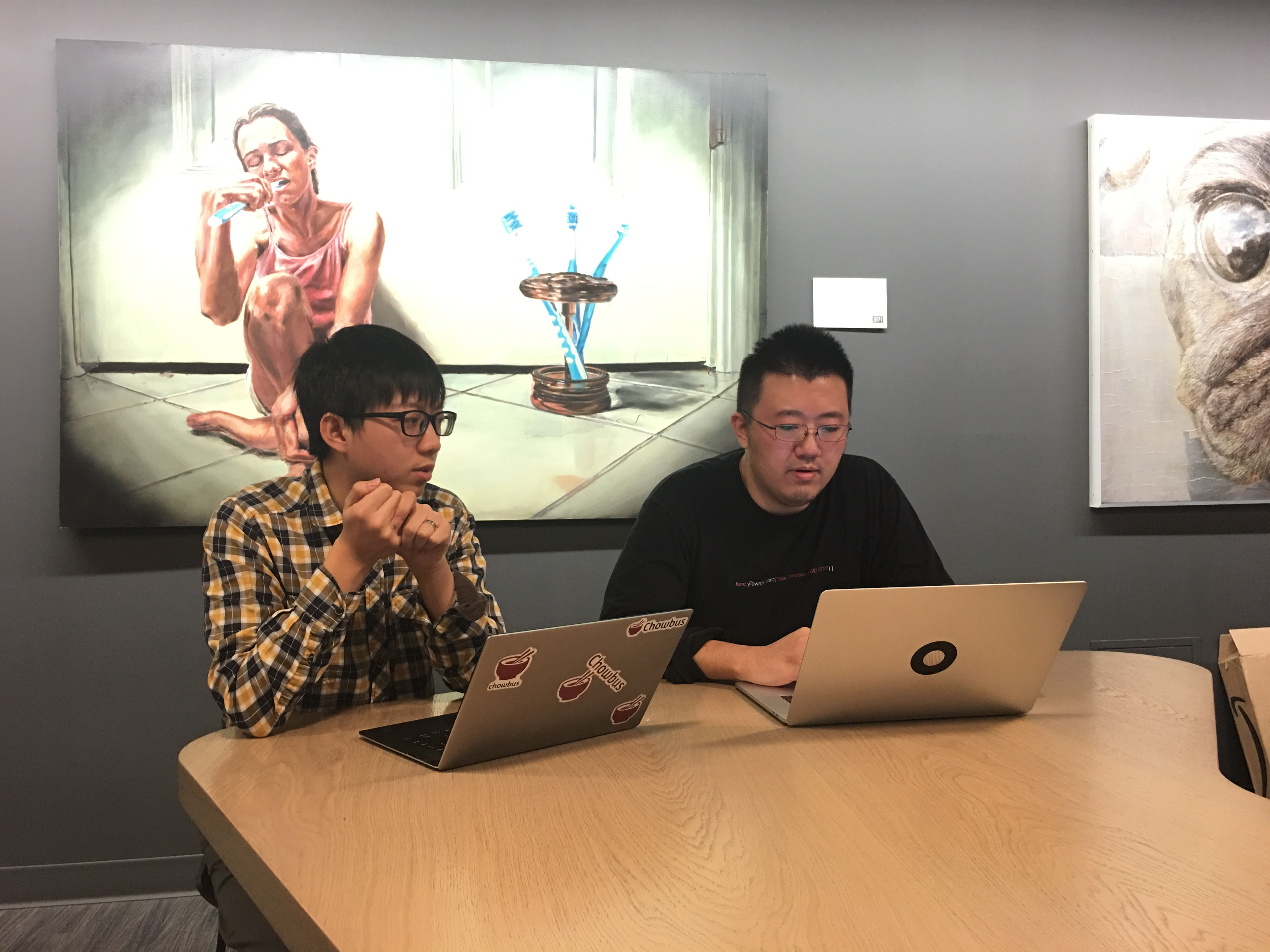 Linxin Wen, left, and Suyu Zhang working at laptops inside Chicago’s 1871 incubator