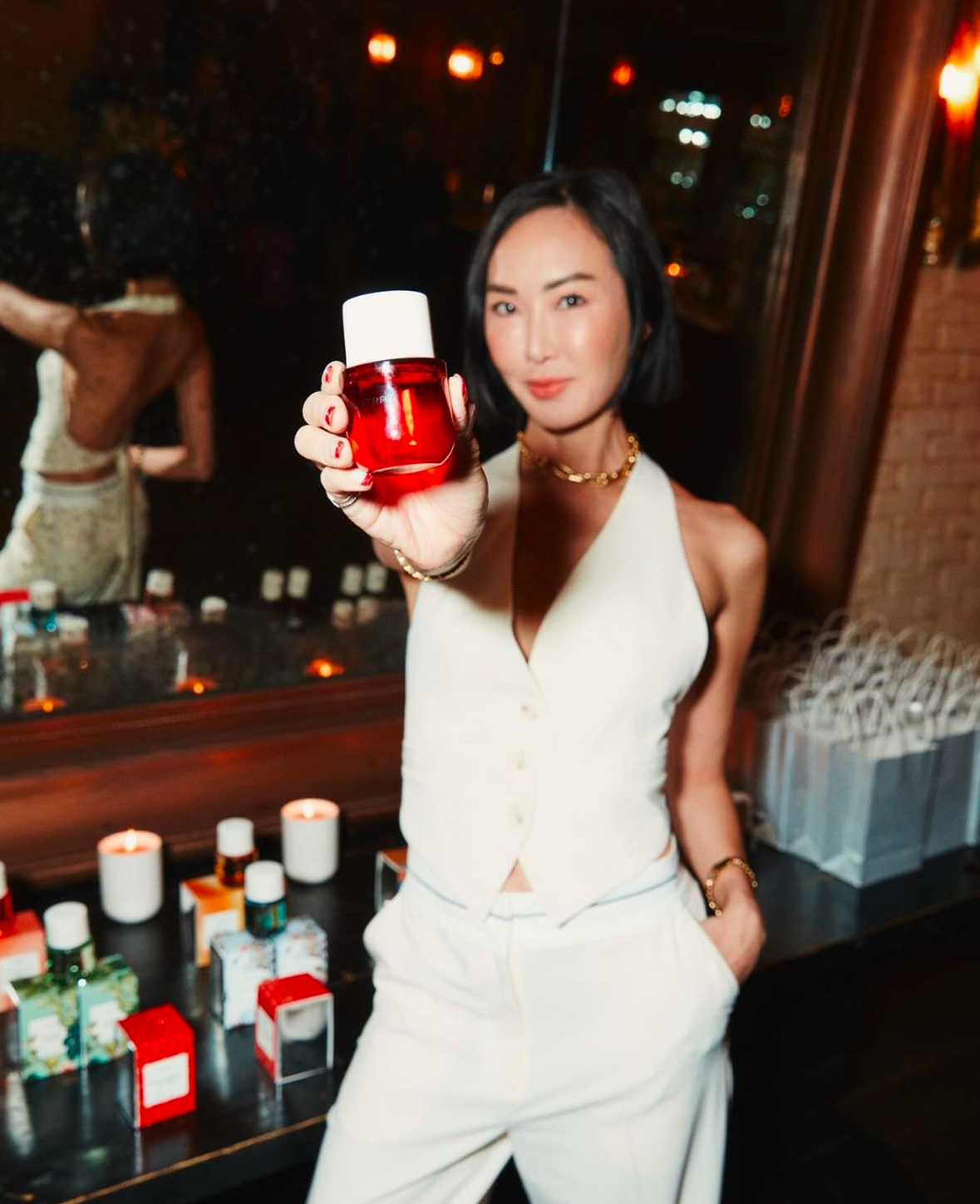 A PHLUR bottle held toward the camera at an event, from LION’s portfolio