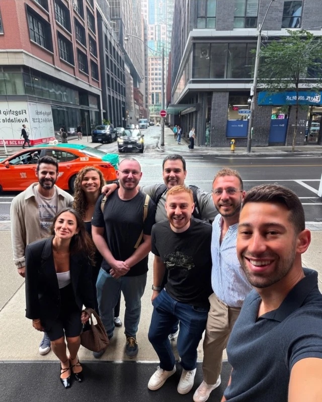 Lior Pozin taking a group selfie outdoors near Times Square