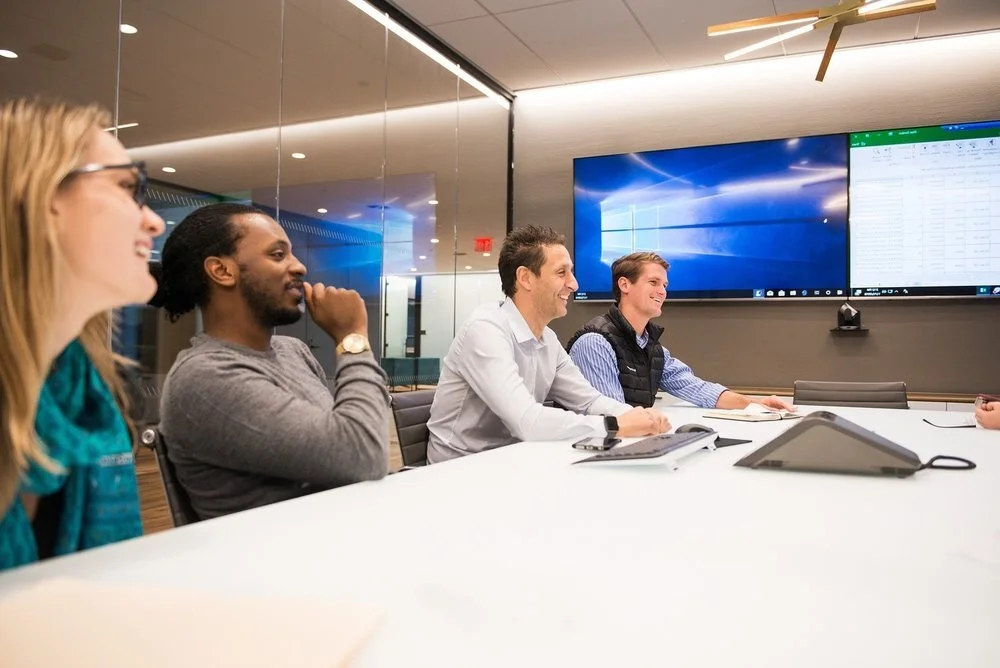 Liquidnet employees discussing trading technology around a conference table