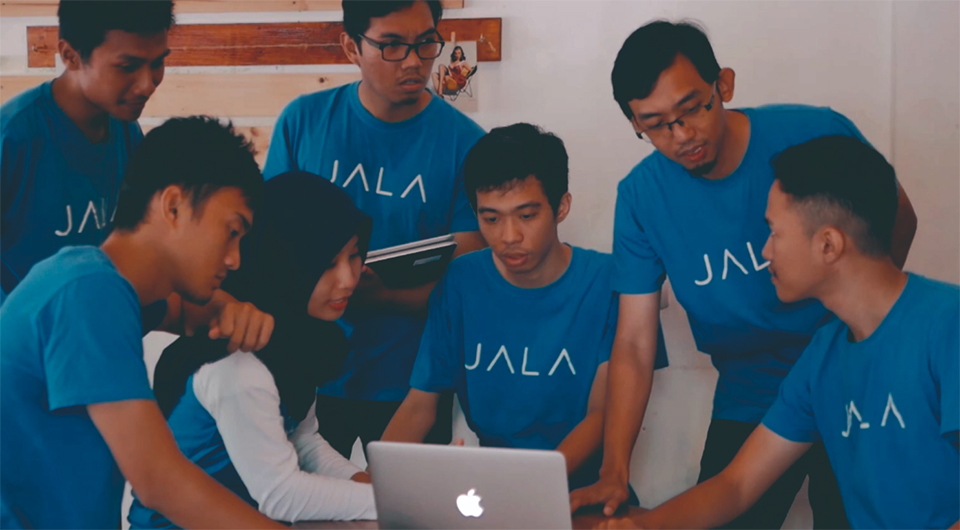Members of the early JALA team standing together outdoors