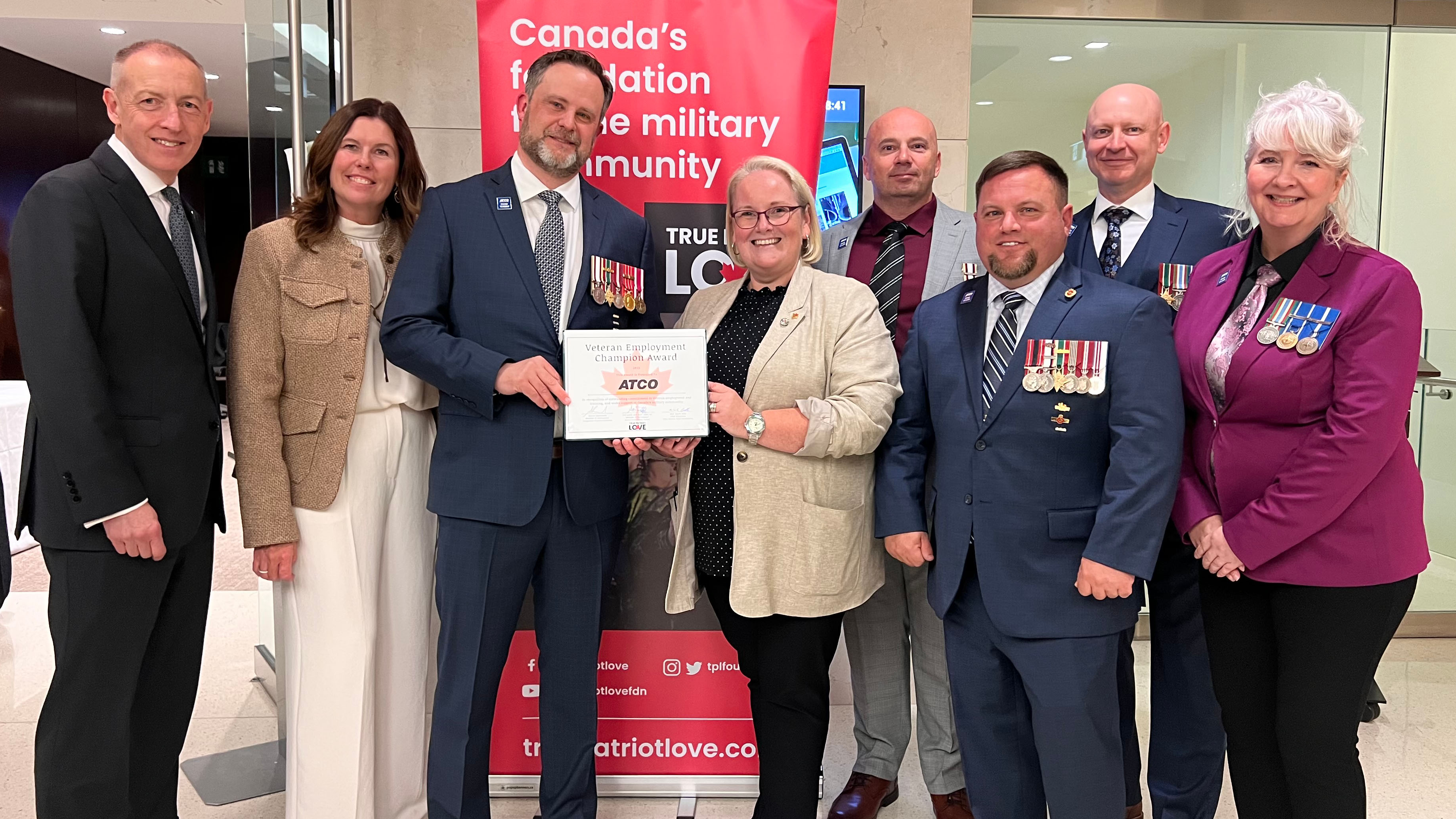 Lisa Cooke stands with ATCO colleagues, veterans and True Patriot Love representatives at the 2025 Veteran Employment Champion Award event