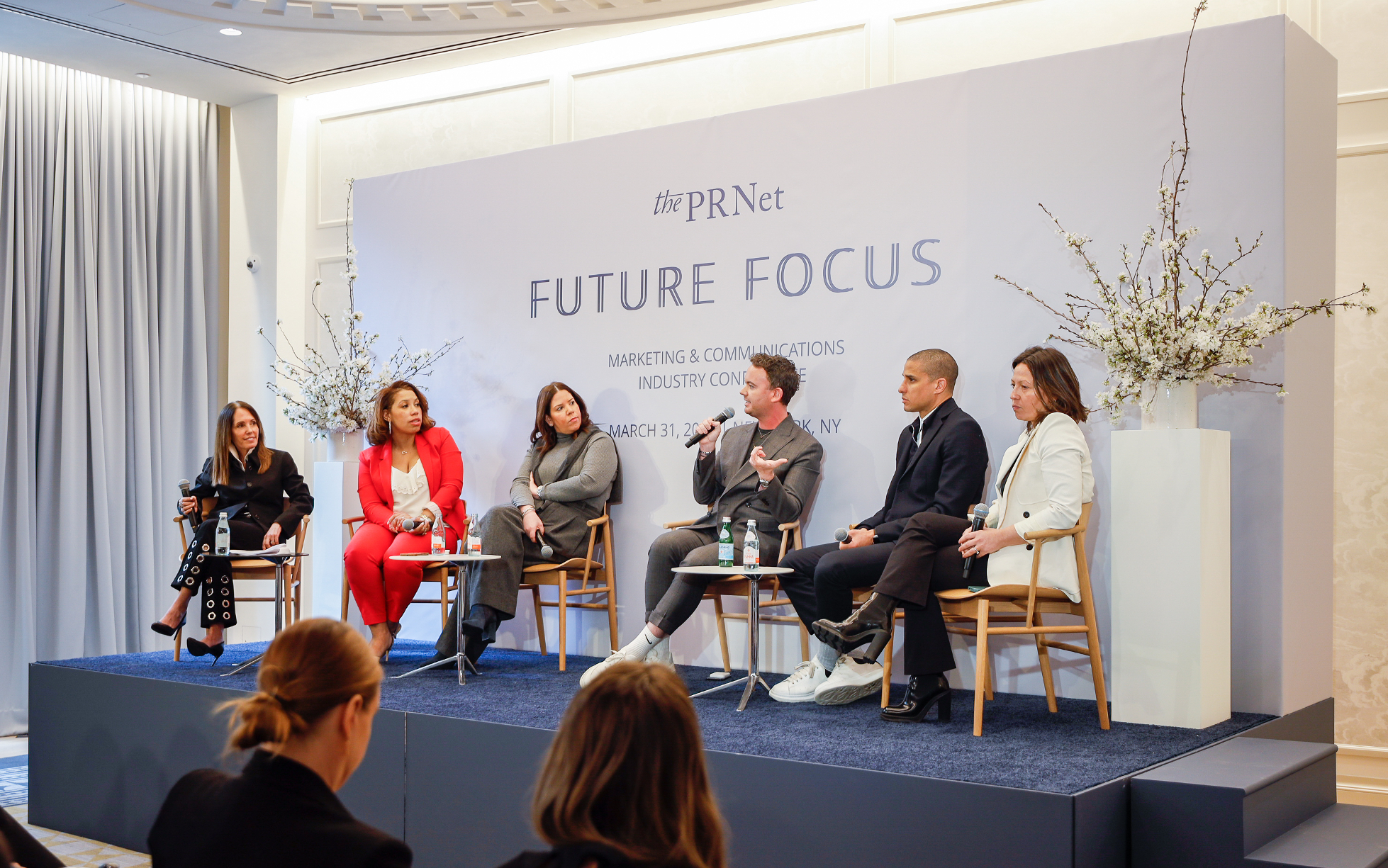 Lisa Frank, third from left, seated with five other speakers on a Future Focus panel