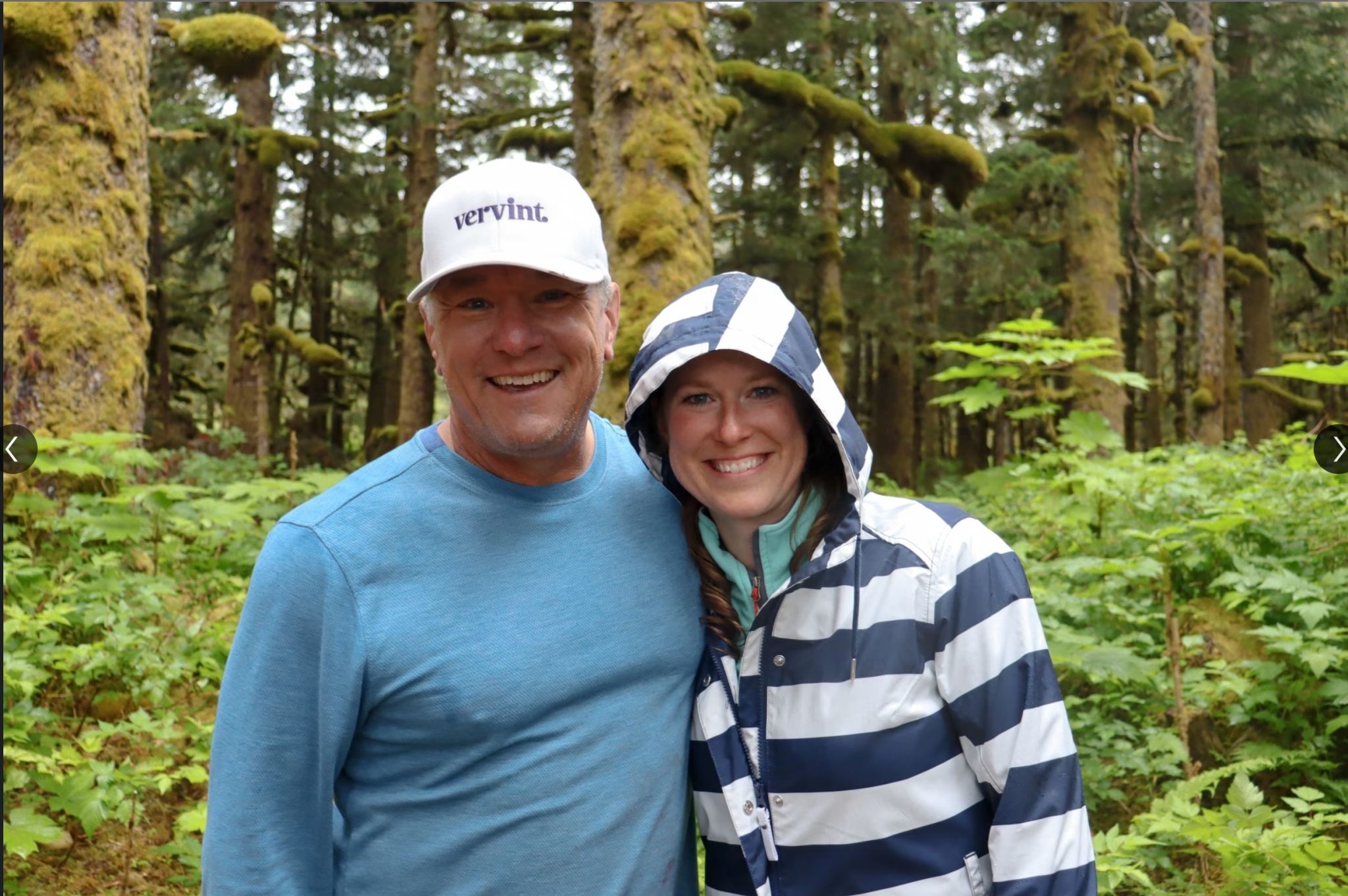 Kyle Nelson and Lisa Jilek standing together among trees during the Alaska community service visit.