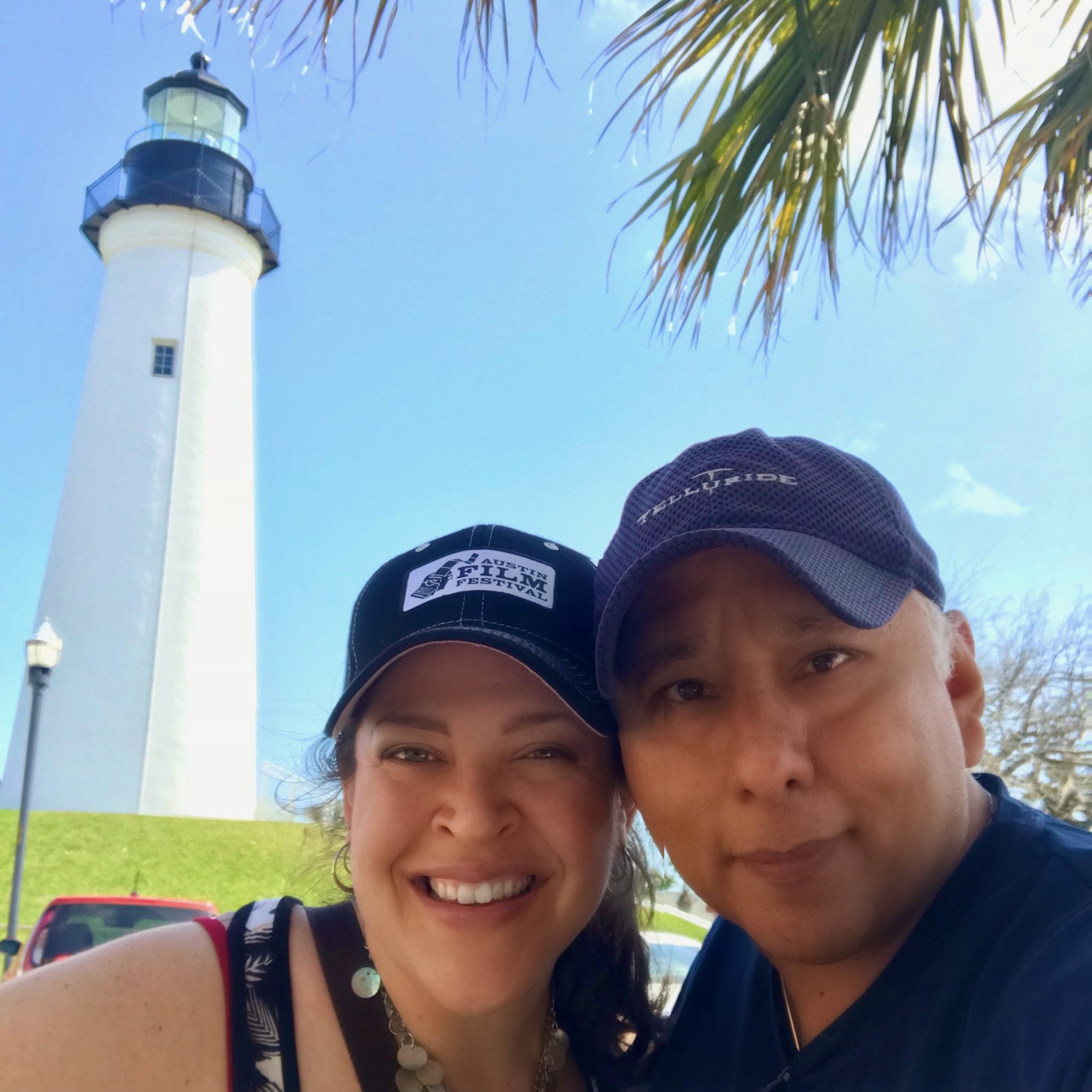Lisa and Mike Martinez smiling in front of a lighthouse