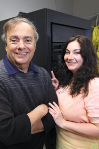 Bob Vormittag and Lisa Vormittag standing beside enterprise computing equipment