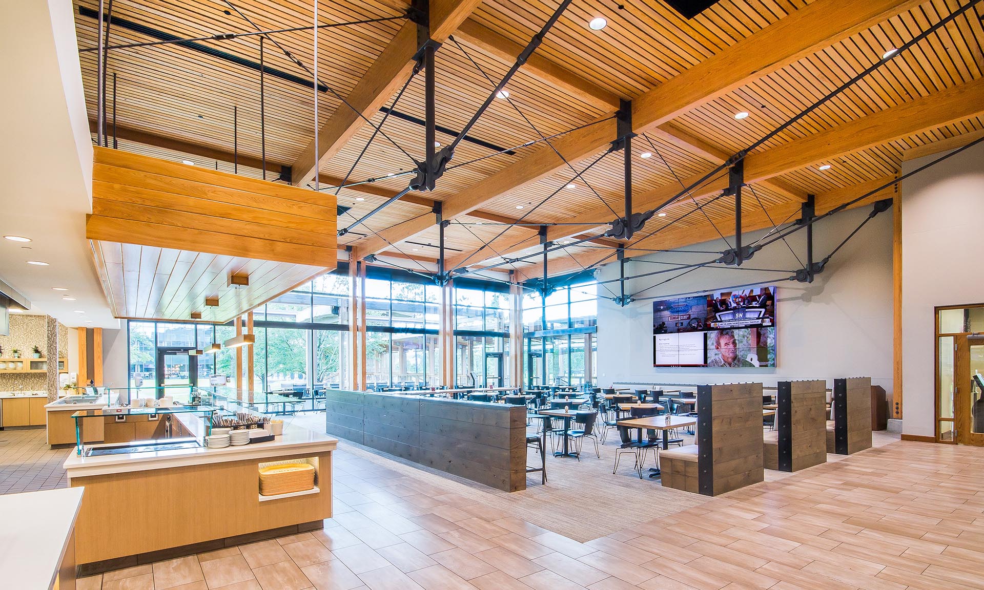 Exposed timber beams and large windows inside The Grove at Live Oak Bank