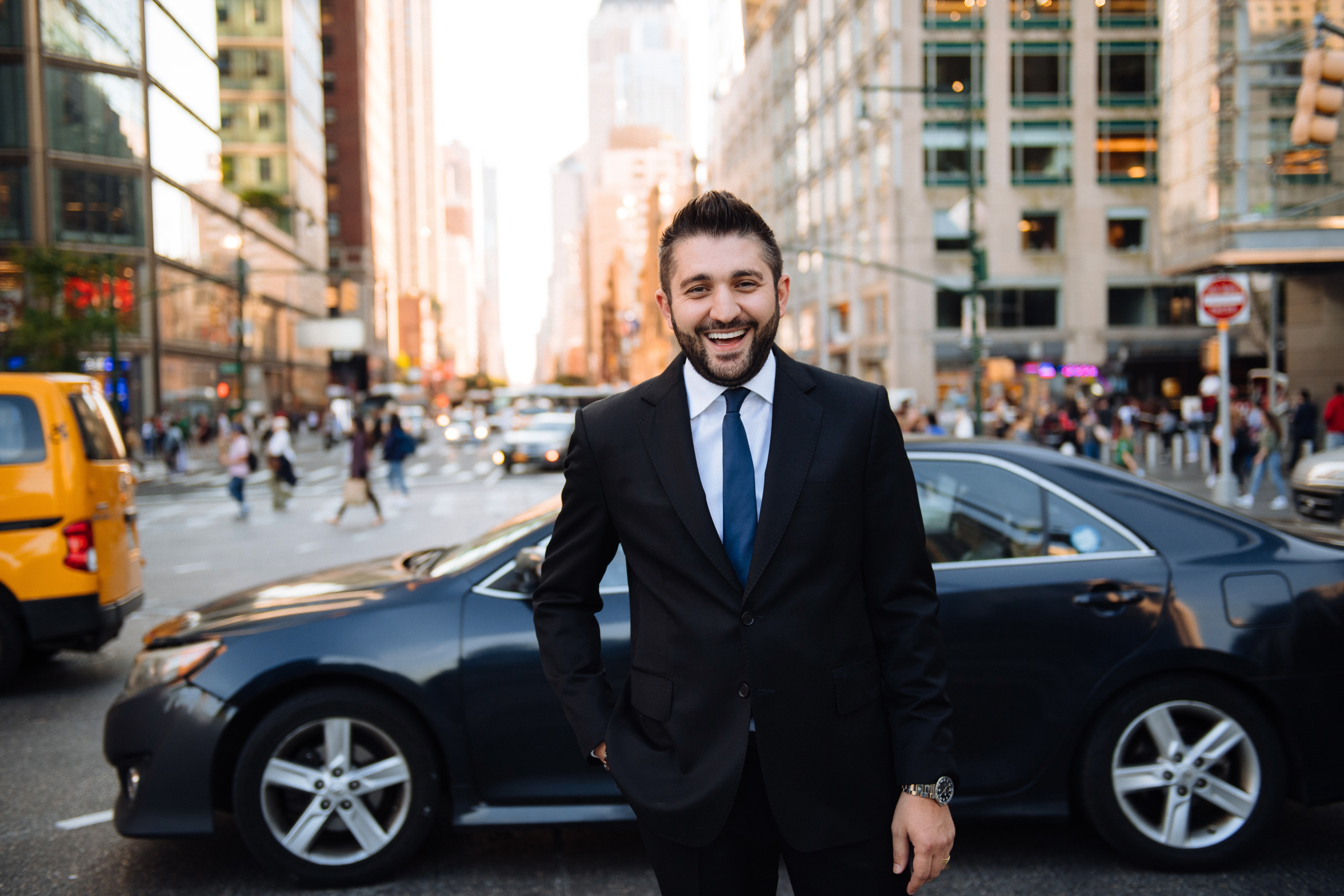 Liviu Tanase in a dark suit on a New York City street