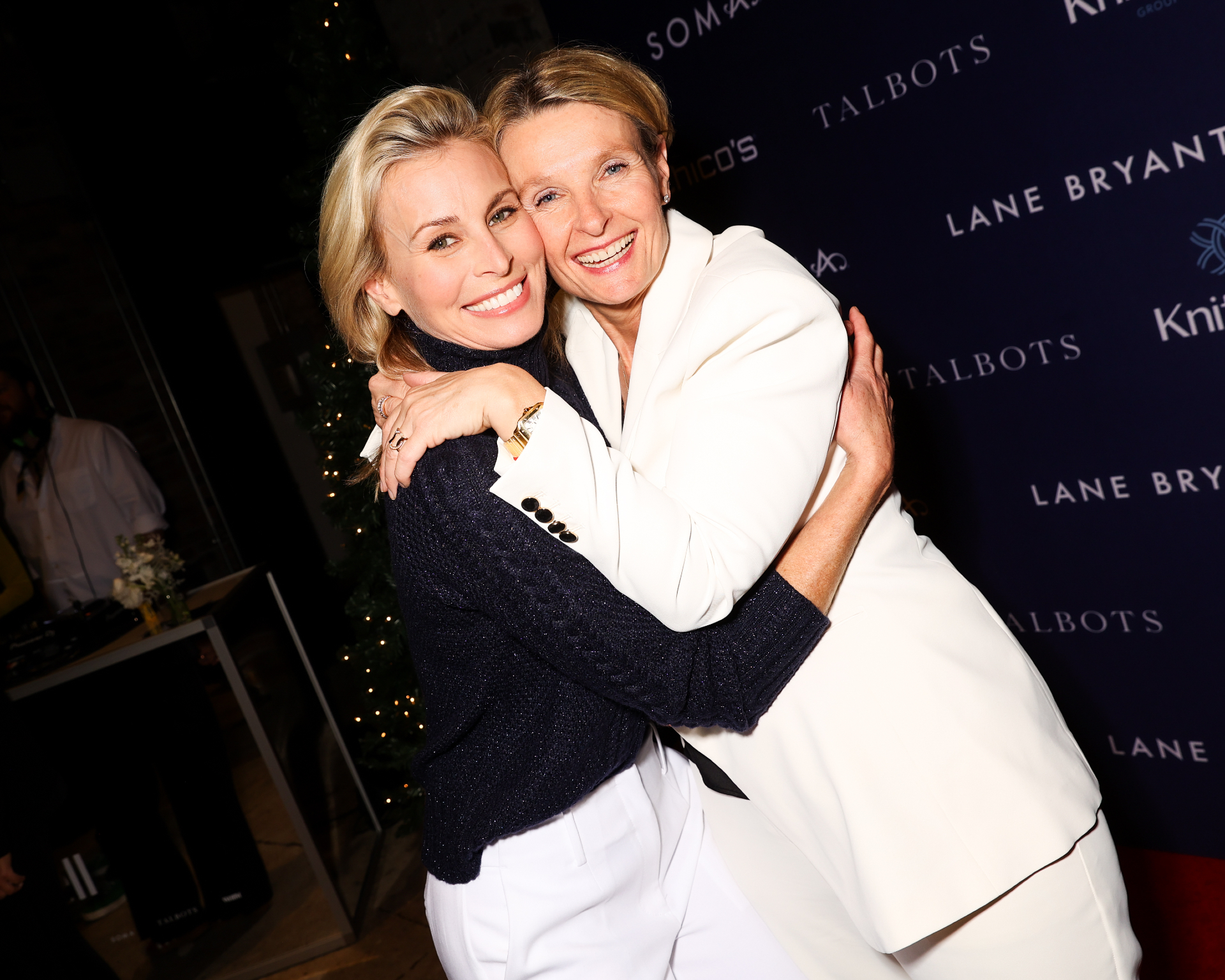 Niki Taylor and Lizanne Kindler embracing at KnitWell Group’s 2025 Holiday House event