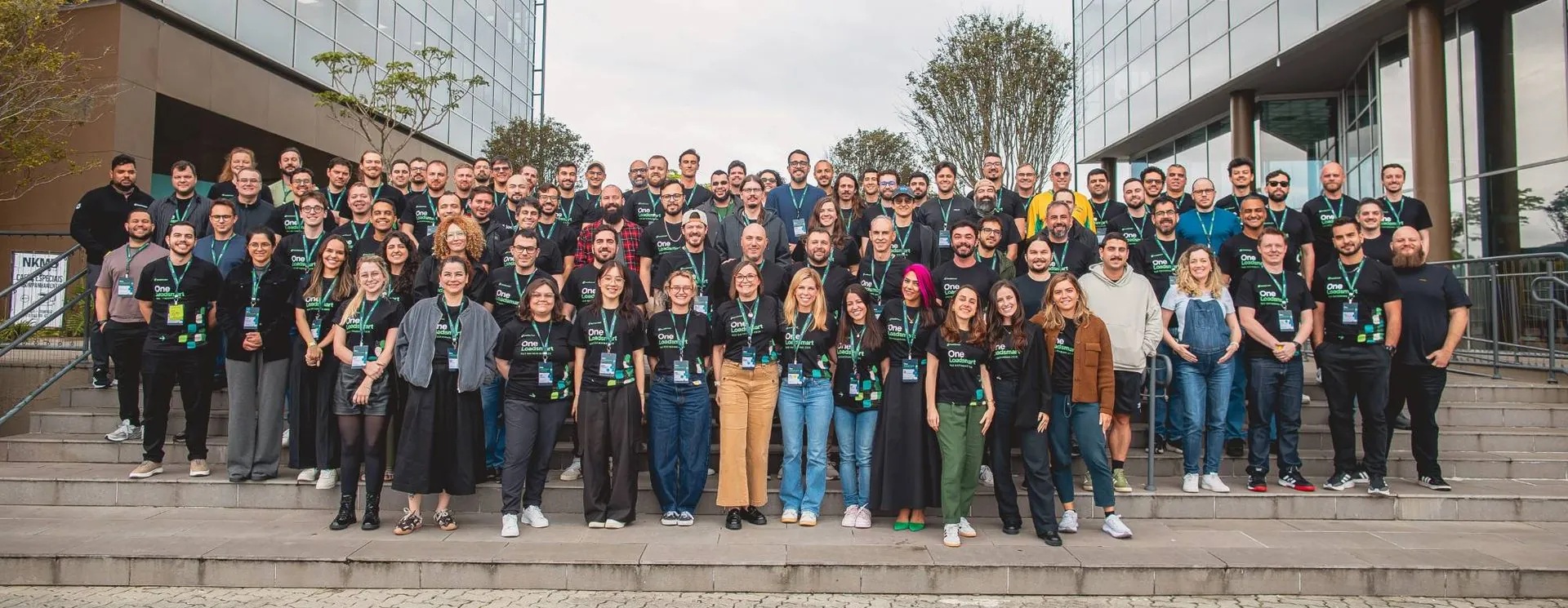 Loadsmart employees gathered outside a glass office building