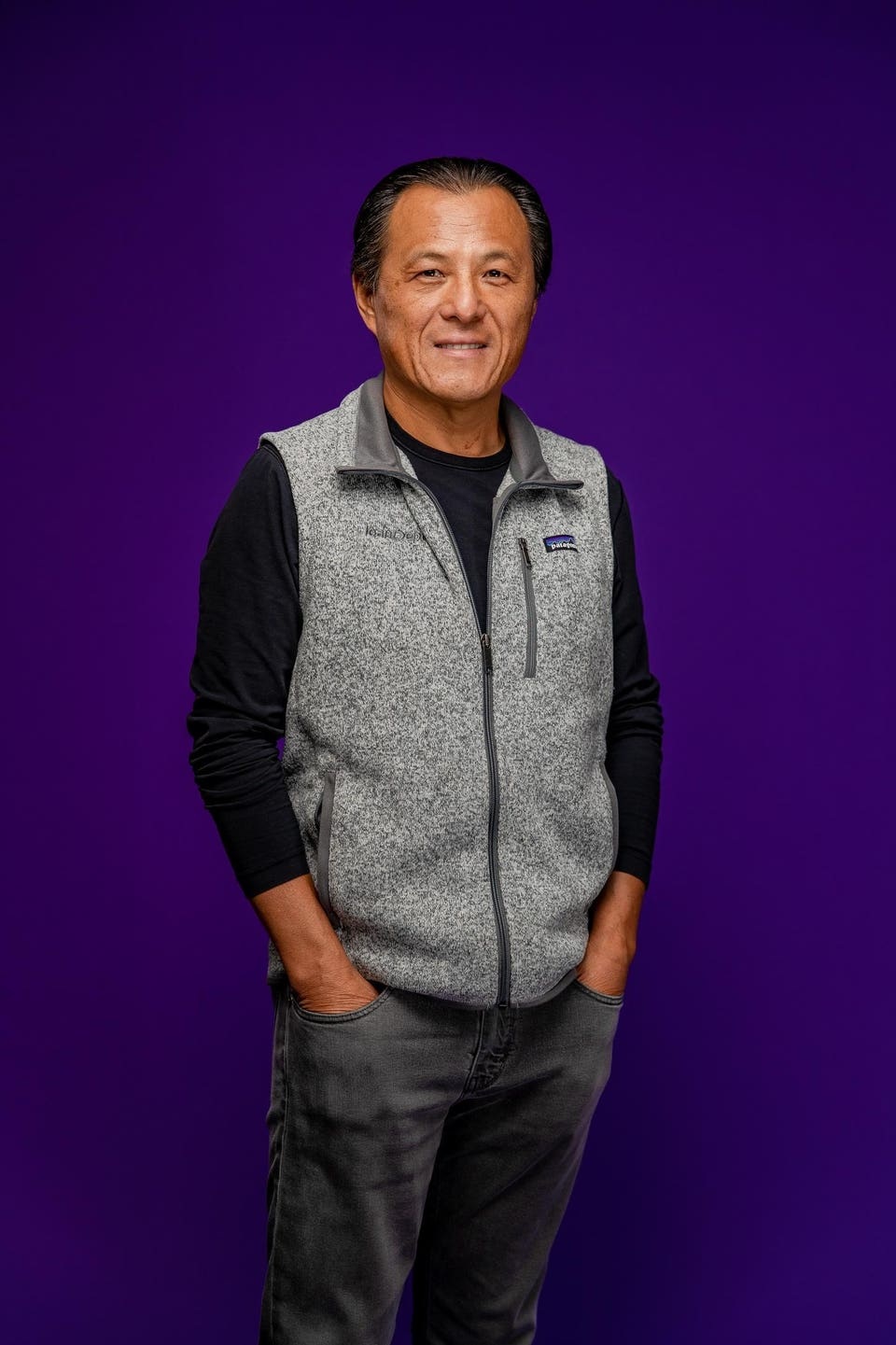 loanDepot founder Anthony Hsieh wearing a gray vest against a purple background