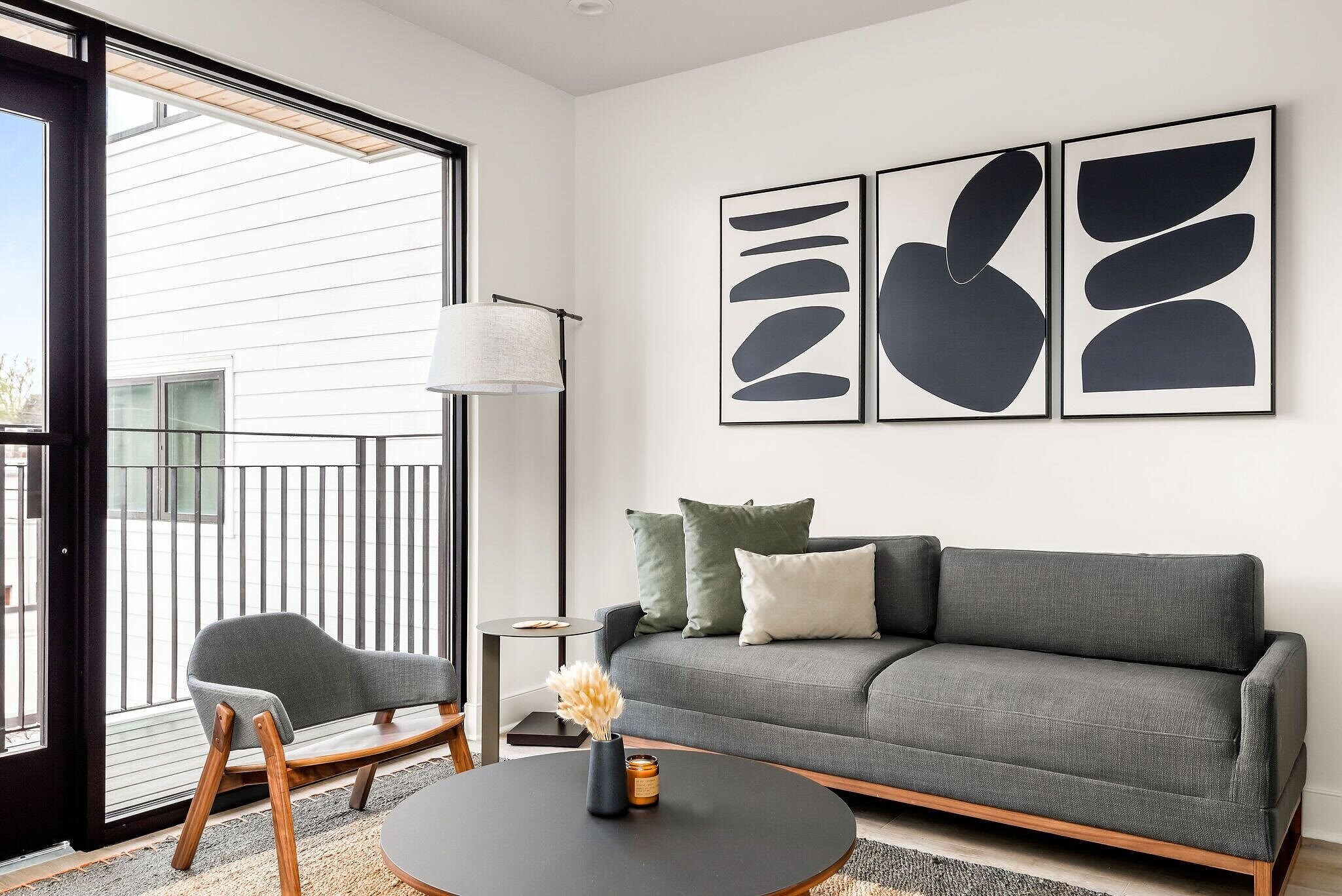 Furnished living room with a sofa and dining space at The Eighteen