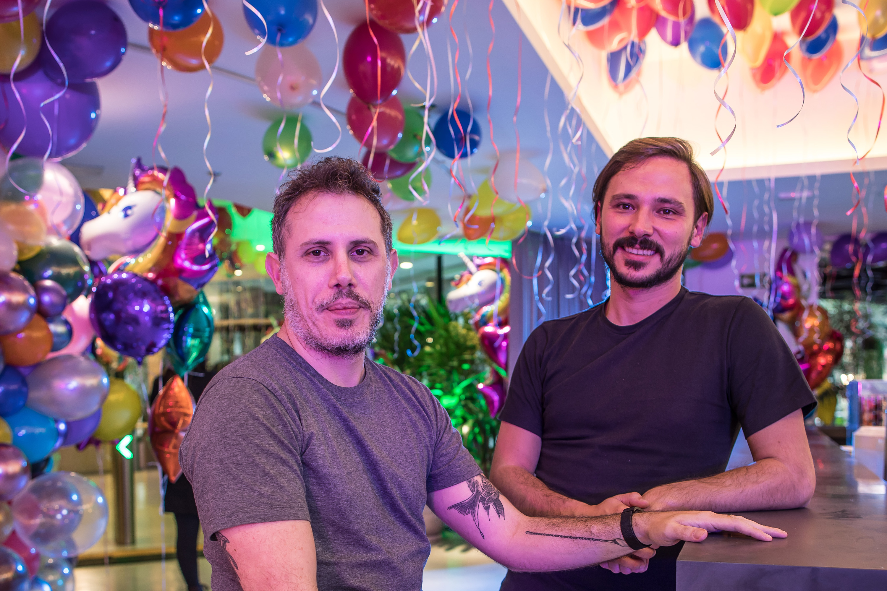 Loggi co-founders Arthur Debert and Fabien Mendez beneath balloons at the company’s 2019 celebration