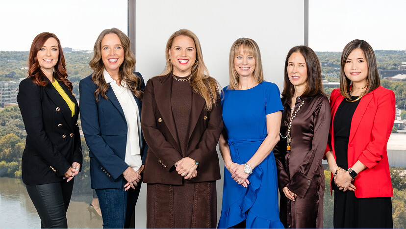 Members of LogicMonitor's leadership team standing together in an office