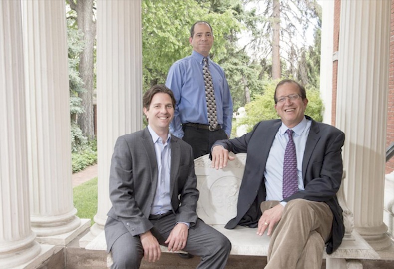 Three members of LogRhythm’s early leadership pictured outdoors in a historical company photograph