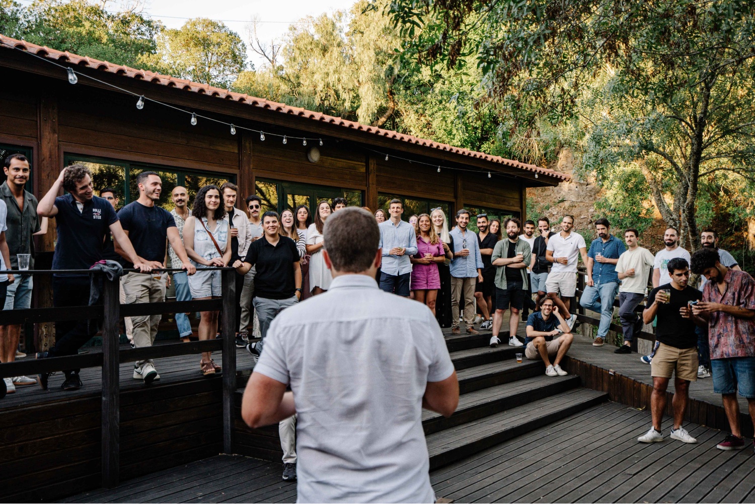 Loka employees gathering outdoors in Portugal as Ricardo Grizonic addresses the group