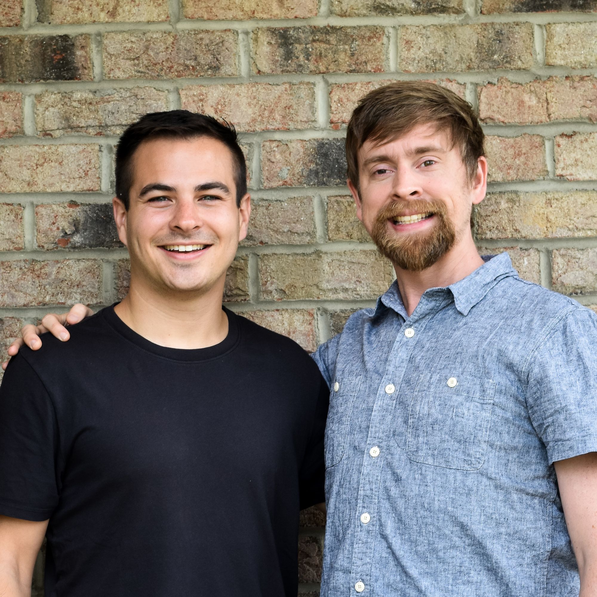 Lolli co-founders Alex Adelman, left, and Matt Senter standing together in front of a brick wall