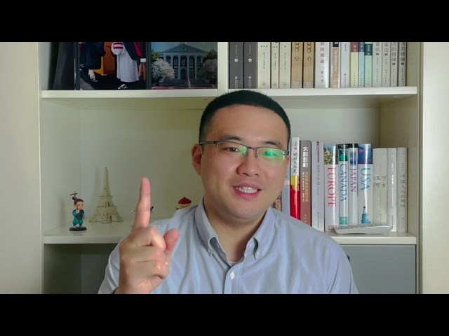 Long Lu speaking to camera with bookshelves behind him