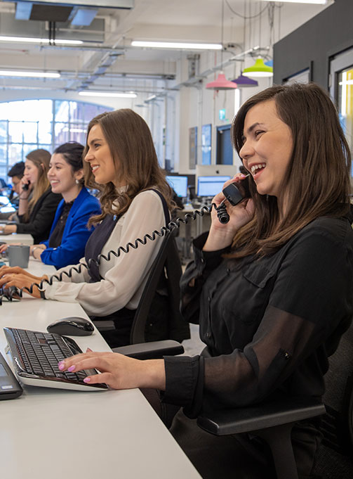 Members of LoopUp's London team working with telephone headsets