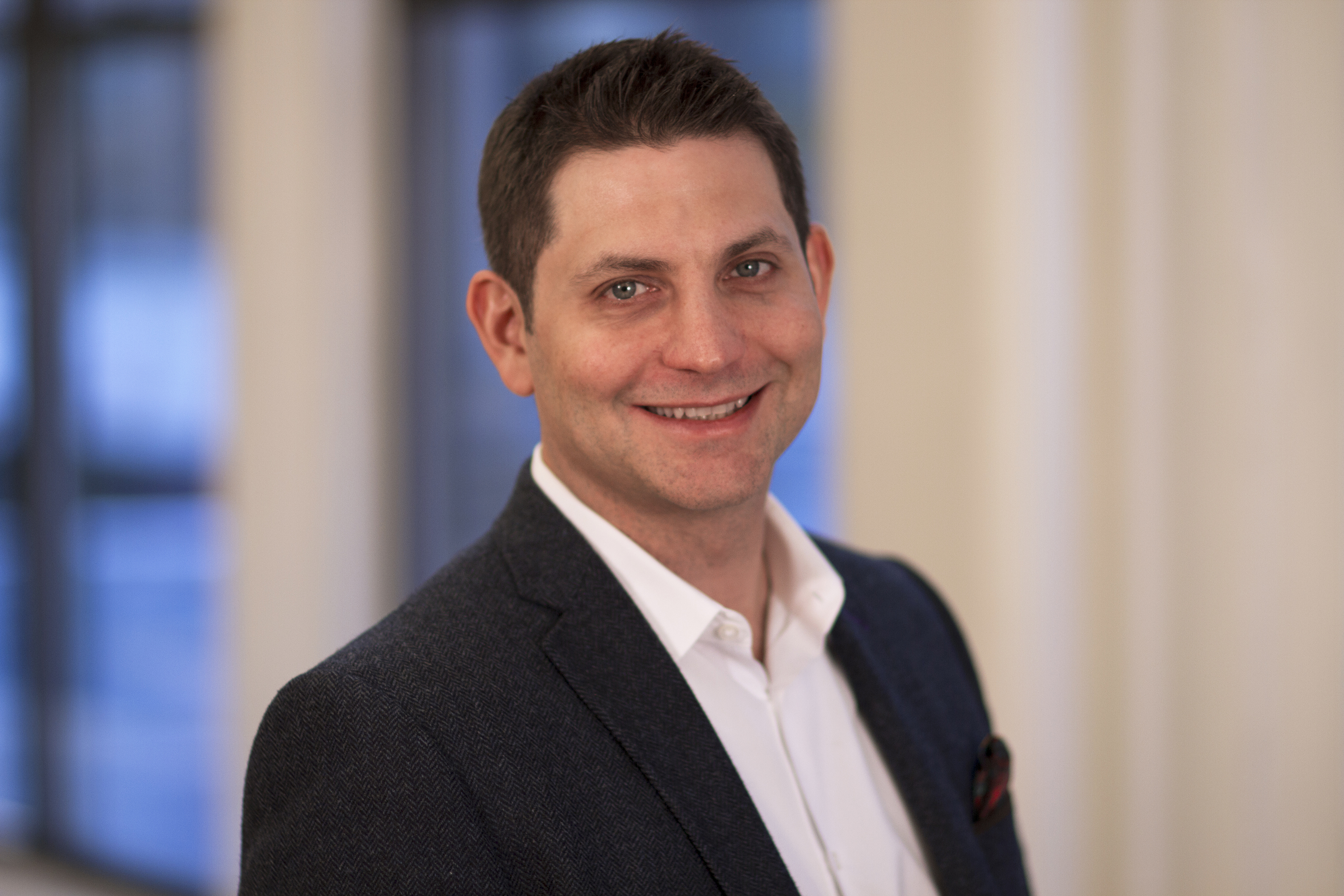 Lorne Brown in a dark jacket and white shirt, photographed for his MediaVillage author profile
