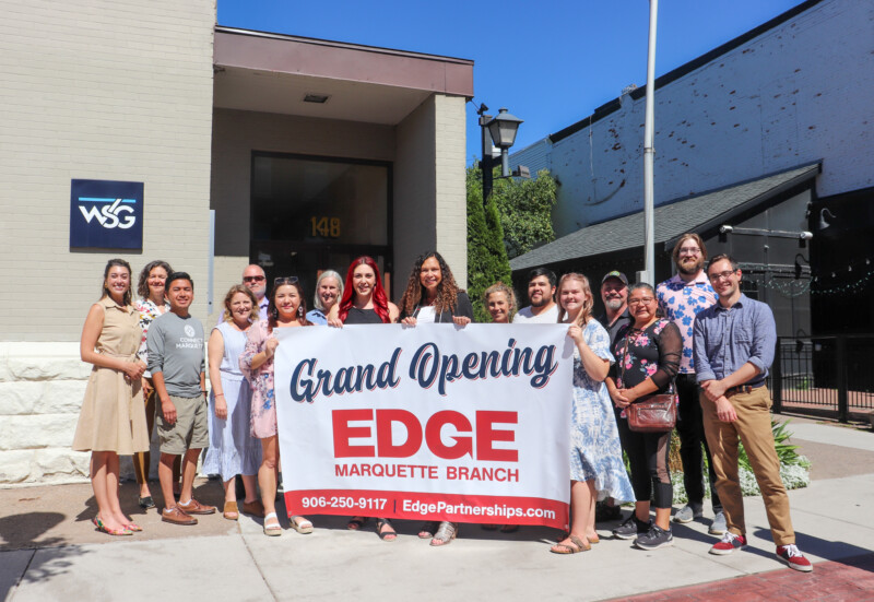 Lorri Rishar Jandron with community representatives at Edge’s Marquette grand opening in August 2022