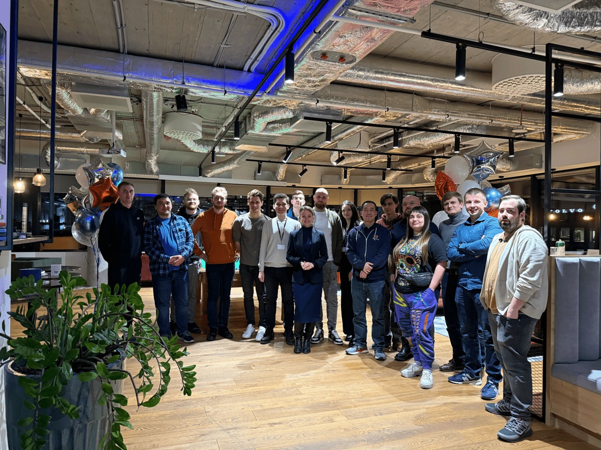LotusFlare team members standing together in an office with balloons
