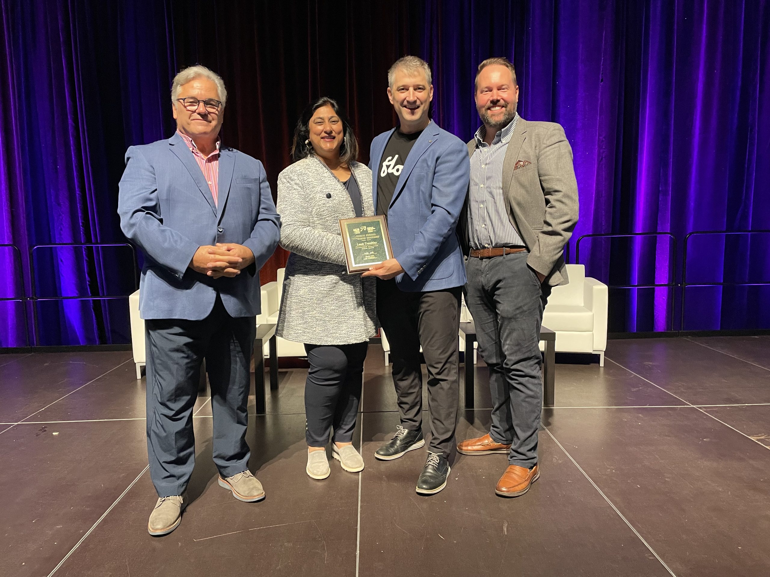 Louis Tremblay, third from left, holding his Al Cormier Award at an Electric Mobility Canada event