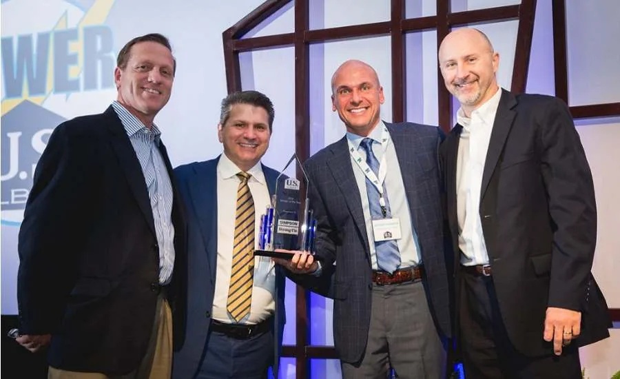 LT Gibson, second from left, with Simpson Strong-Tie and US LBM colleagues at a supplier award presentation.