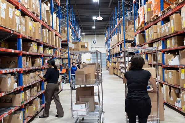 Workers picking products from tall warehouse racks at Medusa Distribution