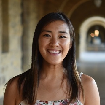 Lucia Huang smiling in an outdoor arcade, in the photograph accompanying her 2021 podcast conversation