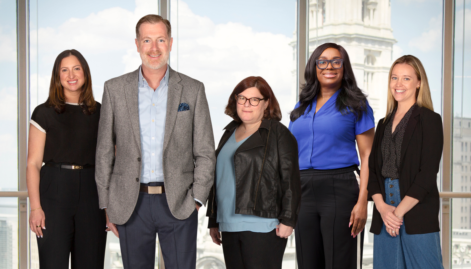 Five leaders from Lucid Group US standing together in a bright office