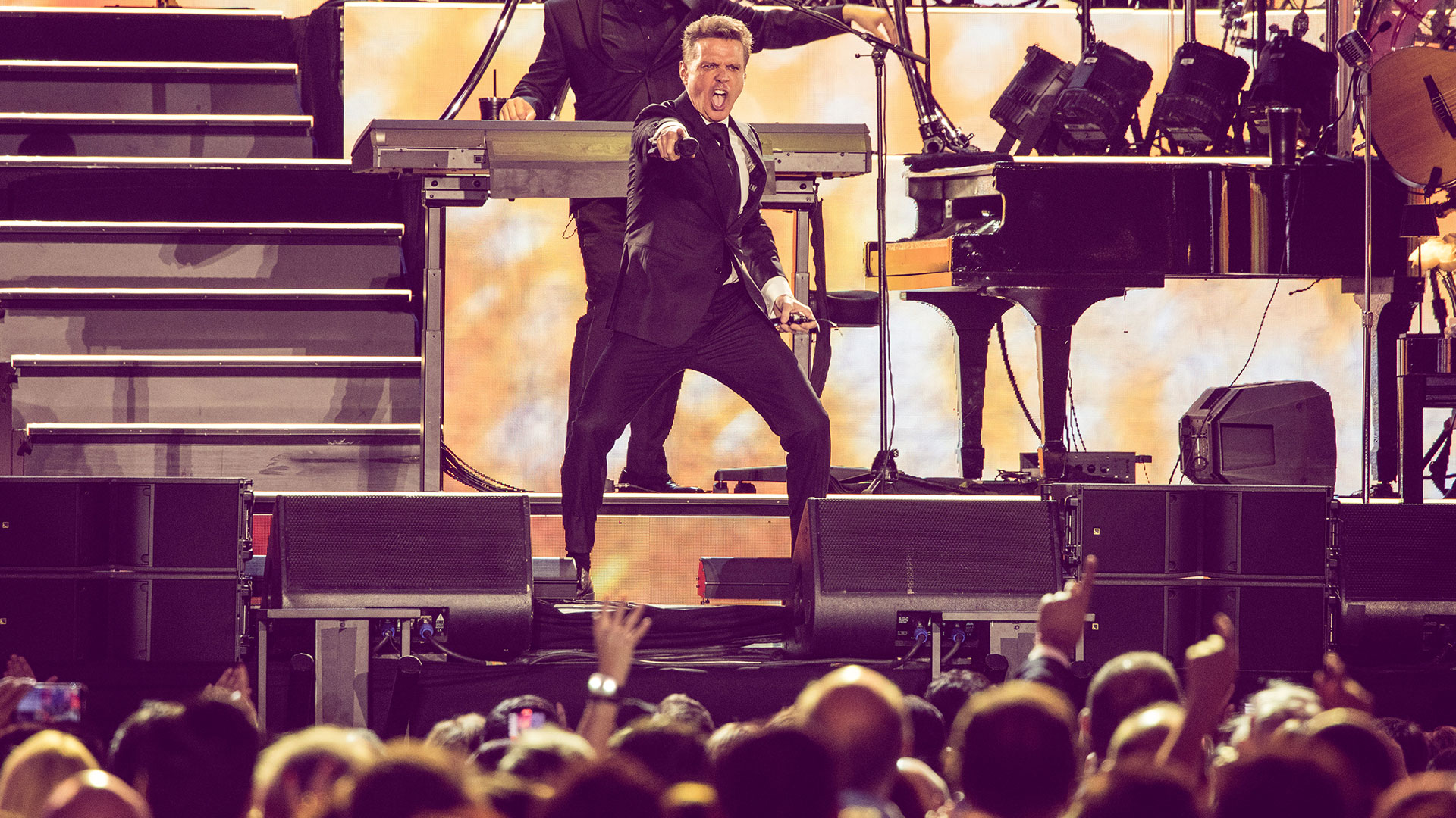 Luis Miguel performing in a dark suit at Santiago Bernabéu Stadium in Madrid in July 2024