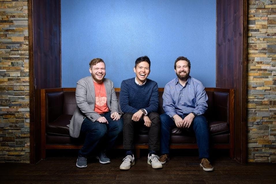 Redox co-founders James Lloyd, Niko Skievaski and Luke Bonney sitting together on a bench