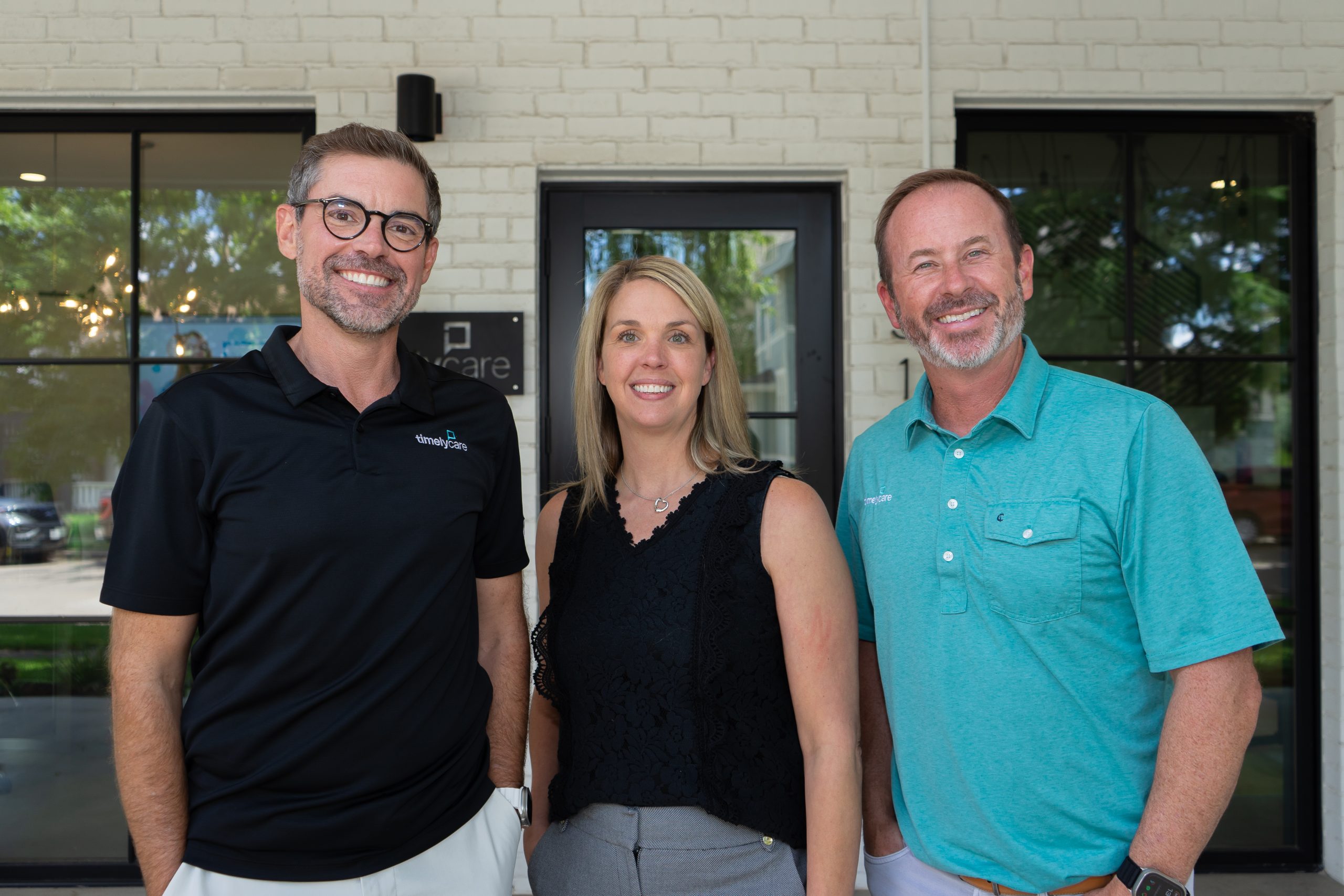 Luke Hejl, Jacki Craft and Bob Booth standing together outside TimelyCare’s Fort Worth headquarters