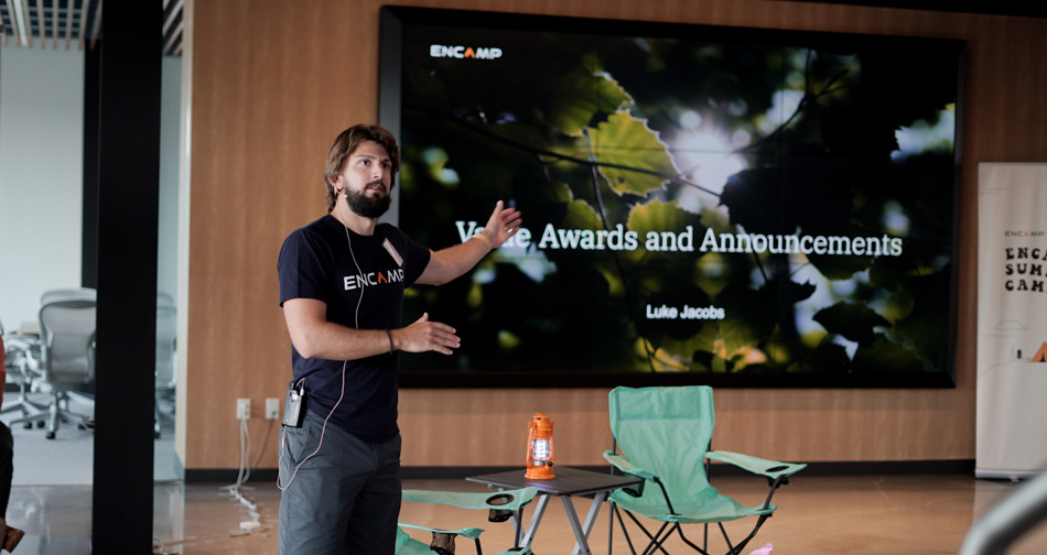 Luke Jacobs gestures while speaking to the Encamp team at Summer Camp in 2021