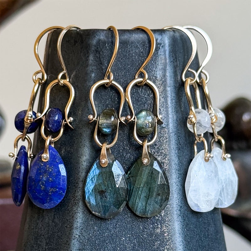 Lulu Designs gemstone drop earrings displayed on stone